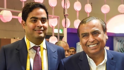 Reliance Industries Ltd Chairman Mukesh Ambani with his son and Reliance Jio chairman Akash Ambani during the 6th India Mobile Congress at Pragati Maidan in New Delhi, (PTI) Reliance Industries Ltd Chairman Mukesh Ambani with his son and Reliance Jio chairman Akash Ambani during the 6th India Mobile Congress at Pragati Maidan in New Delhi, (PTI)