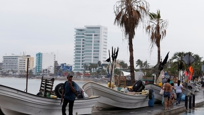 Hurricane Orlene In Mexico: A man walks past boats being stored out of the water on the seafront as Hurricane Orlene approaches Mexico. (Reuters)