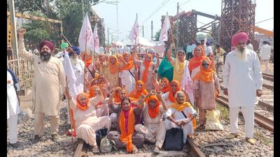 Farmers blocking a rail track during a protest against the central government at Vallah in Amritsar district on Monday, the first anniversary of the Lakhimpur Kheri violence. (Sameer Sehgal/HT) Farmers blocking a rail track during a protest against the central government at Vallah in Amritsar district on Monday, the first anniversary of the Lakhimpur Kheri violence. (Sameer Sehgal/HT)