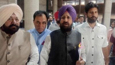 Punjab Congress members, led by Partap Singh Bajwa (centre) and Amrinder Singh Raja Warring (right), walking out of the assembly in Chandigarh on Monday. (Ravi Kumar/HT)