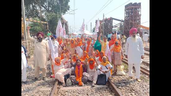 Farmers block a railway track at Vallah in Amritsar during a protest against the Centre on Monday. (HT photo ( Sameer Sehgal))