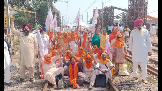 Farmers blocking a rail track during a protest against the central government at Vallah in Amritsar district on Monday, the first anniversary of the Lakhimpur Kheri violence. (Sameer Sehgal/HT)