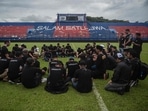 Indonesia Stadium Stampede: Players and officials from Arema Football Club gather to pray on the pitch for victims of the stampede at Kanjuruhan stadium in Malang, East Java. Indonesia Stadium Stampede: Players and officials from Arema Football Club gather to pray on the pitch for victims of the stampede at Kanjuruhan stadium in Malang, East Java.