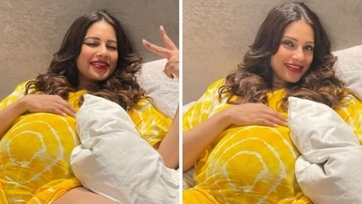 Bipasha Basu in a yellow outfit showing her baby bump. Bipasha Basu in a yellow outfit showing her baby bump. 