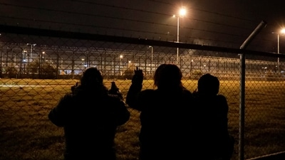 Ecuador Prison Violence: Family members of inmates look through the fence at the Cotopaxi No 1 penitentiary while waiting for news on their loved ones, in Latacunga, Ecuador. (Reuters)
