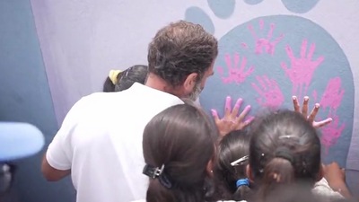 Rahul Gandhi and some school children also put out imprints of their hands on one the school walls. Rahul Gandhi and some school children also put out imprints of their hands on one the school walls.