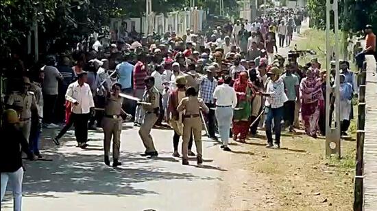 Porbandar: Police personnel stop a crowd of locals over a demolition drive in Porbandar's Memonwada area on Tuesday. (ANI)