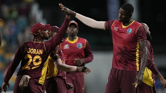West Indies' captain Nicholas Pooran celebrates with teammate Jason Holder(AP) West Indies' captain Nicholas Pooran celebrates with teammate Jason Holder(AP)