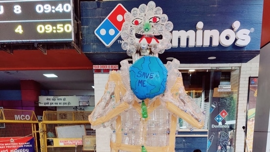 The demon shaped sculpture that is made out of plastic bottles is grabbing the public attention as it was placed at the entrance of the busy railway station.