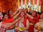 Sindoor Khela 2022: Durga Puja comes to an end for this year. The festival started with Mahalaya on September 26 and ended with Vijaya Dashami on October 5. Sindoor khela is one of the main attractions of Durga Puja when married women smear vermillion on the faces of each other.(Praful Gangurde / HT Photo)
