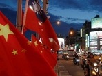 China-Taiwan Conflict: Flags of China and Taiwan flutter next to each other during a rally in Taipei, Taiwan. China-Taiwan Conflict: Flags of China and Taiwan flutter next to each other during a rally in Taipei, Taiwan.