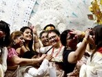 Women take part in Sindoor Khela - a Bengali Hindu tradition where women smear each other with sindoor on Vijayadashami in New Delhi on Wednesday.(HT Photo/Sanjeev Verma)