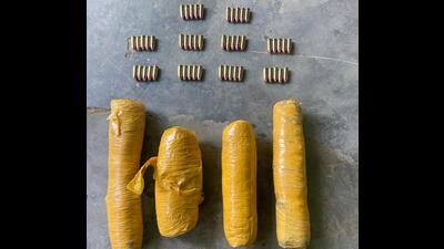 The four packets of contraband and ammunition recovered by the BSF from a field of Bharopal village in Ajnala sub division of Amritsar district on Wednesday. (HT Photo)
