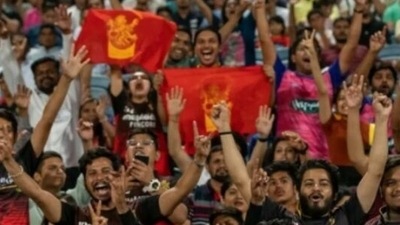 RCB fans cheer during IPL match. RCB fans cheer during IPL match.