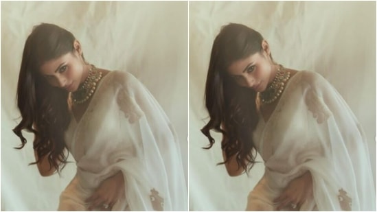 Mouni teamed her saree with a white sleeveless blouse with a plunging neckline. In statement necklace, she looked fashion-ready.(Instagram/@imouniroy)