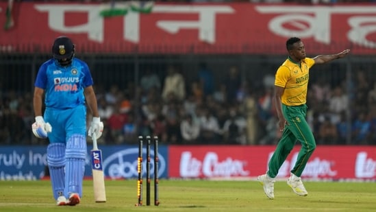 South Africa's Kagiso Rabada celebrates the wicket of India's captain Rohit Sharma, left, during the third T20 cricket match&nbsp;(AP)