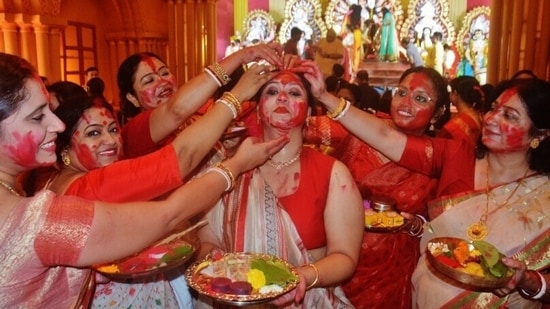 Sindoor Khela 2022: Durga Puja comes to an end for this year. The festival started with Mahalaya on September 26 and ended with Vijaya Dashami on October 5. Sindoor khela is one of the main attractions of Durga Puja when married women smear vermillion on the faces of each other.(Praful Gangurde / HT Photo)