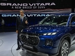 The managing director and chief executive officer of Maruti Suzuki India Limited (MSIL) Hisashi Takeuchi poses with the new SUV Grand Vitara during its global unveiling ceremony in Gurgaon on July 20, 2022. (Photo by Prakash SINGH / AFP)