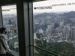 North Korea: A man looks at the view near a window (R) displaying the distance to the North Korean capital, Pyongyang, at the landmark Namsan Tower in Seoul. North Korea: A man looks at the view near a window (R) displaying the distance to the North Korean capital, Pyongyang, at the landmark Namsan Tower in Seoul.