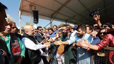 Union home minister Amit Shah greets the crowd gathered for his rally in J&K’s Baramulla on Wednesday. (ANI) Union home minister Amit Shah greets the crowd gathered for his rally in J&K’s Baramulla on Wednesday. (ANI)