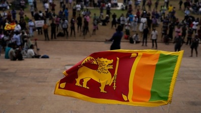 Sri Lanka Economic Crisis: A Sri Lankan flag is waved in Colombo, Sri Lanka, (AP) Sri Lanka Economic Crisis: A Sri Lankan flag is waved in Colombo, Sri Lanka, (AP)