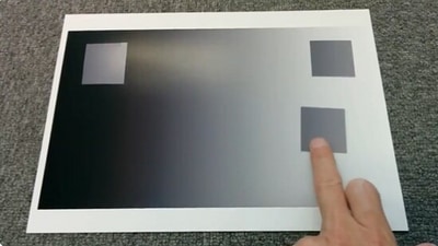 The image, taken from the viral Twitter video, shows an optical illusion made with paper involving a ‘colour-changing’ square. (Twitter/@AkiyoshiKitaoka)