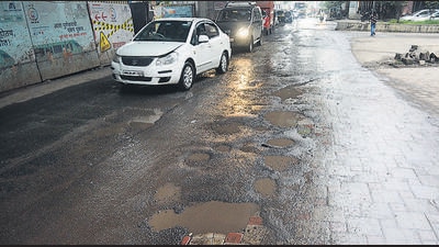 Vehicles make their way through a pothole-ridden road near Kalyani Nagar on Thursday. (Shankar Narayan/HT PHOTO) Vehicles make their way through a pothole-ridden road near Kalyani Nagar on Thursday. (Shankar Narayan/HT PHOTO)