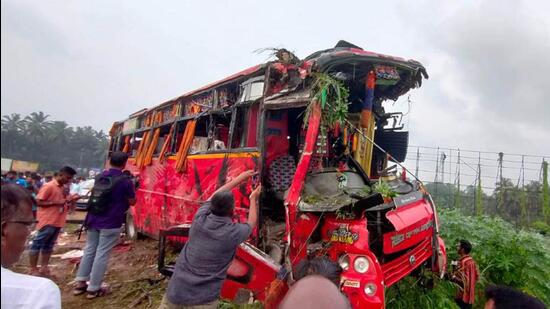 Locals at the site of the accident after a collision between a private tourist bus and a KSRTC bus on Wednesday night, at Vadakkenchery in Palakkad district. (PTI)