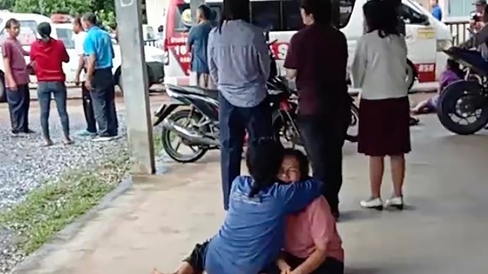 Thailand Daycare Centre Shooting: A distraught woman is comforted outside the site of an attack at a daycare canter,(AP)