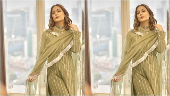 Hina decked up in a moss green long salwar featuring a closed neckline. The full-sleeved salwar also came with silver zari details at the neckline and throughout the salwar in stripes.(Instagram/@realhinakhan)