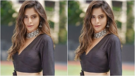 Aamna decked up in a blouse with a plunging neckline and teamed it with a long black silk flowy skirt with details in white at the ankles. She added more festive vibes with a black dupatta with patterns in white.(Instagram/@aamnasharifofficial)