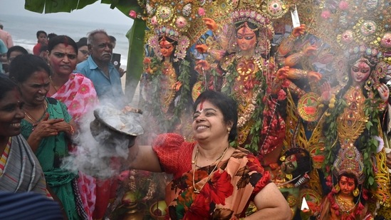 Organisers of most household and community pujas were seen leading colourful processions to the ghats amid the beating of drums.(AFP)