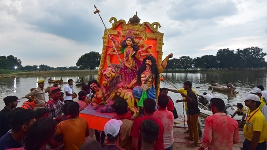 Devotees carry an idol of the Hindu Goddess Durga for immersion in a pond during the final day of the Durga Puja festival on the outskirts of Allahabad.(AFP)