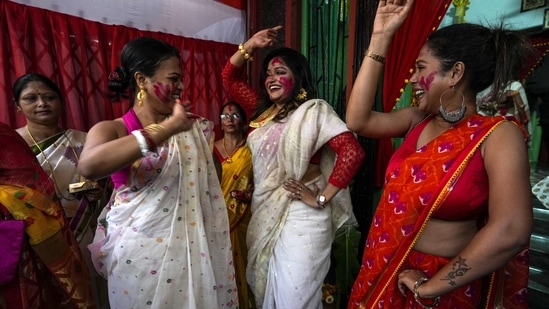 Shortly after the immersion, people exchanged sweets and greetings.(AP)