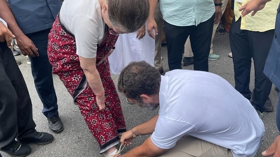Congress party shared this mother-son moment on their Twitter handle, captioning it “Maa” (mother) where rahul Gandhi is seen tying Sonia Gandhi's shoelace as they progress in the march.(Twitter/ @INCIndia)