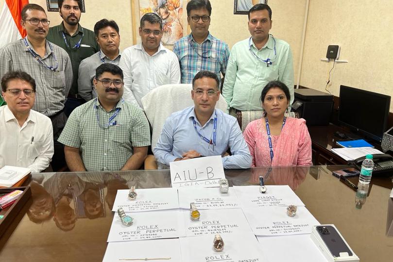 The Customs team pose for a photograph with watches and valuables worth ₹28 crores. (Photo courtesy: Customs) The Customs team pose for a photograph with watches and valuables worth ₹28 crores. (Photo courtesy: Customs)