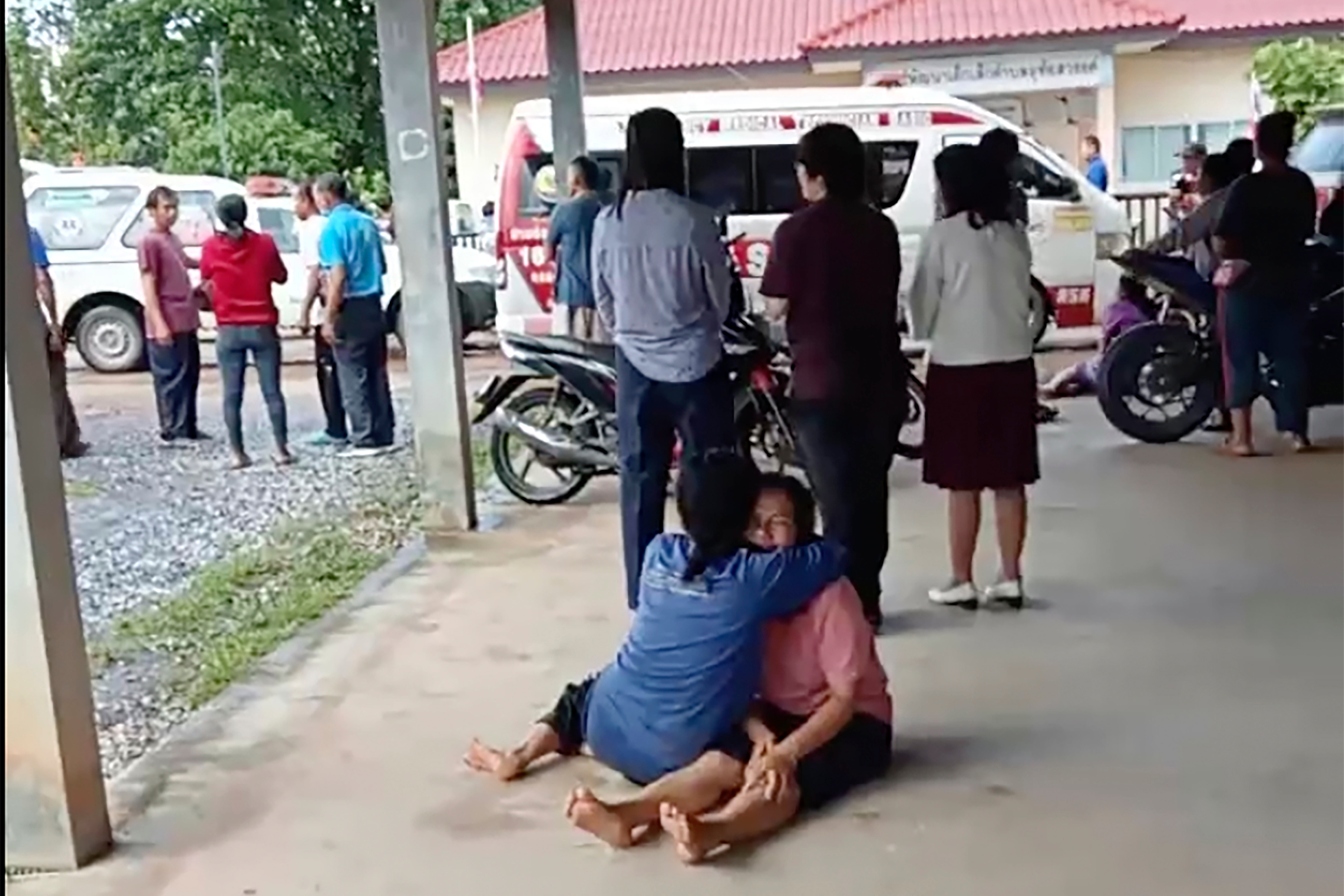 Thailand Daycare Centre Shooting: A distraught woman is comforted outside the site of an attack at a daycare canter, (AP)