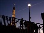 France Energy Crisis: People walk on a bridge next to the Eiffel Tower in Paris France Energy Crisis: People walk on a bridge next to the Eiffel Tower in Paris