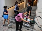 Covid In Hong Kong: An elderly woman pushes her trolleys up a hill in Hong Kong.