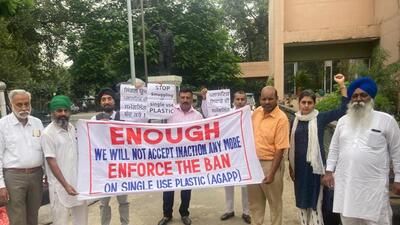 NGO members protesting to seek enforcement of ban on plastic carry bags outside DC office in Ludhiana. (HT PHOTO)