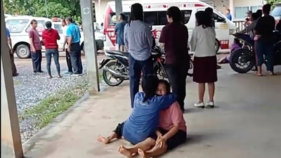 Thailand Daycare Centre Shooting: A distraught woman is comforted outside the site of an attack at a daycare canter, (AP) Thailand Daycare Centre Shooting: A distraught woman is comforted outside the site of an attack at a daycare canter, (AP)