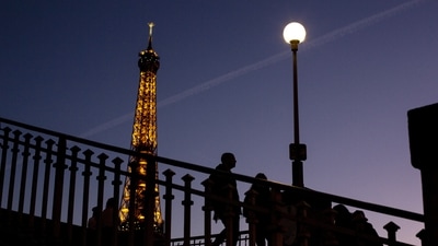 France Energy Crisis: People walk on a bridge next to the Eiffel Tower in Paris (AP)