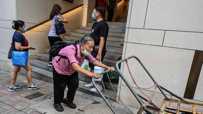 Covid In Hong Kong: An elderly woman pushes her trolleys up a hill in Hong Kong. (AFP) Covid In Hong Kong: An elderly woman pushes her trolleys up a hill in Hong Kong. (AFP)