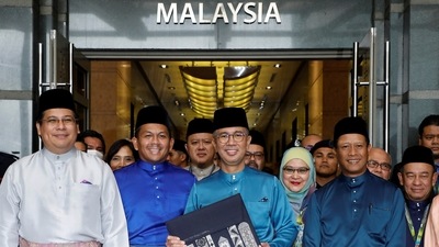 Malaysia's Finance Minister Tengku Zafrul holds a bag containing the 2023 budget at Finance Ministry building as he departs to the Parliament, in Putrajaya, Malaysia, October 7. (REUTERS)