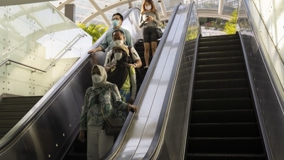 Singapore: Shoppers ride an escalator on Orchard Road in Singapore. (Bloomberg) Singapore: Shoppers ride an escalator on Orchard Road in Singapore. (Bloomberg)