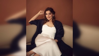 Sonali Bendre wore a white strappy bustier-inspired top paired with a long satin drape skirt and a black trench coat. (Instagram/@iamsonalibendre) Sonali Bendre wore a white strappy bustier-inspired top paired with a long satin drape skirt and a black trench coat. (Instagram/@iamsonalibendre)