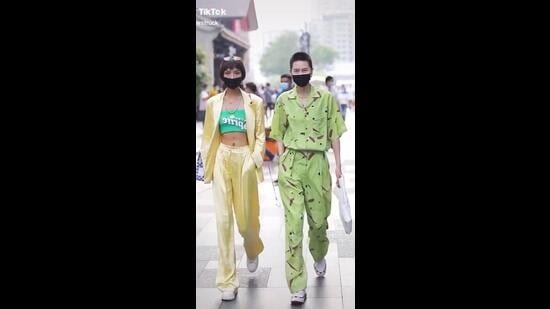 Chinese people walking on the streets of China in street style ensembles (Photo: Twitter)