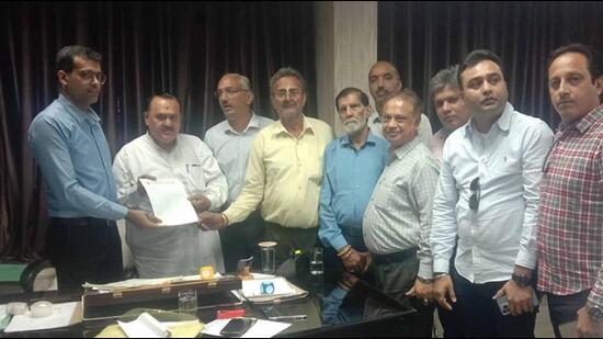 Members of Daresi Ramlila Committee submitting a reply to MC notice regarding encroachments outside fair ground with MC joint commissioner Ankur Mahindroo at Zone A office in Ludhiana. (HT PHOTO)