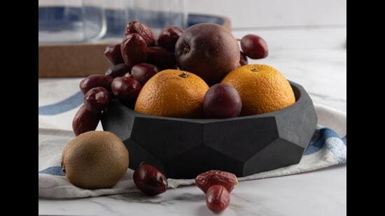 This unusual dark concrete bowl is great as a centrepiece on the dining table. (Nonagon multipurpose and multifaceted bowl by Greyt)