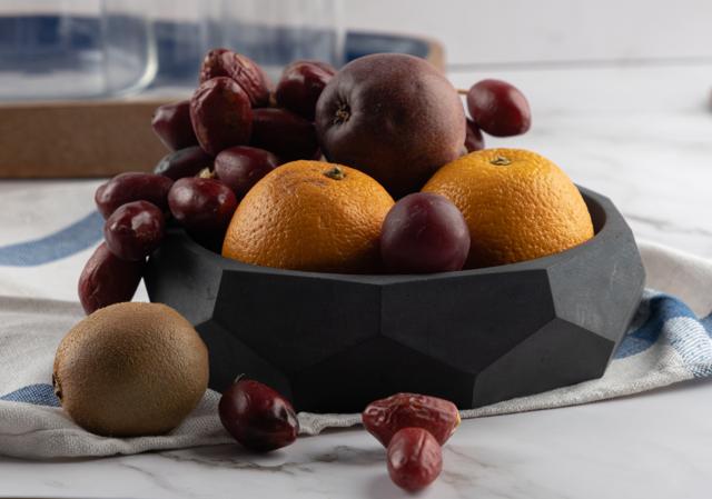 This unusual dark concrete bowl is great as a centrepiece on the dining table. (Nonagon multipurpose and multifaceted bowl by Greyt) This unusual dark concrete bowl is great as a centrepiece on the dining table. (Nonagon multipurpose and multifaceted bowl by Greyt)